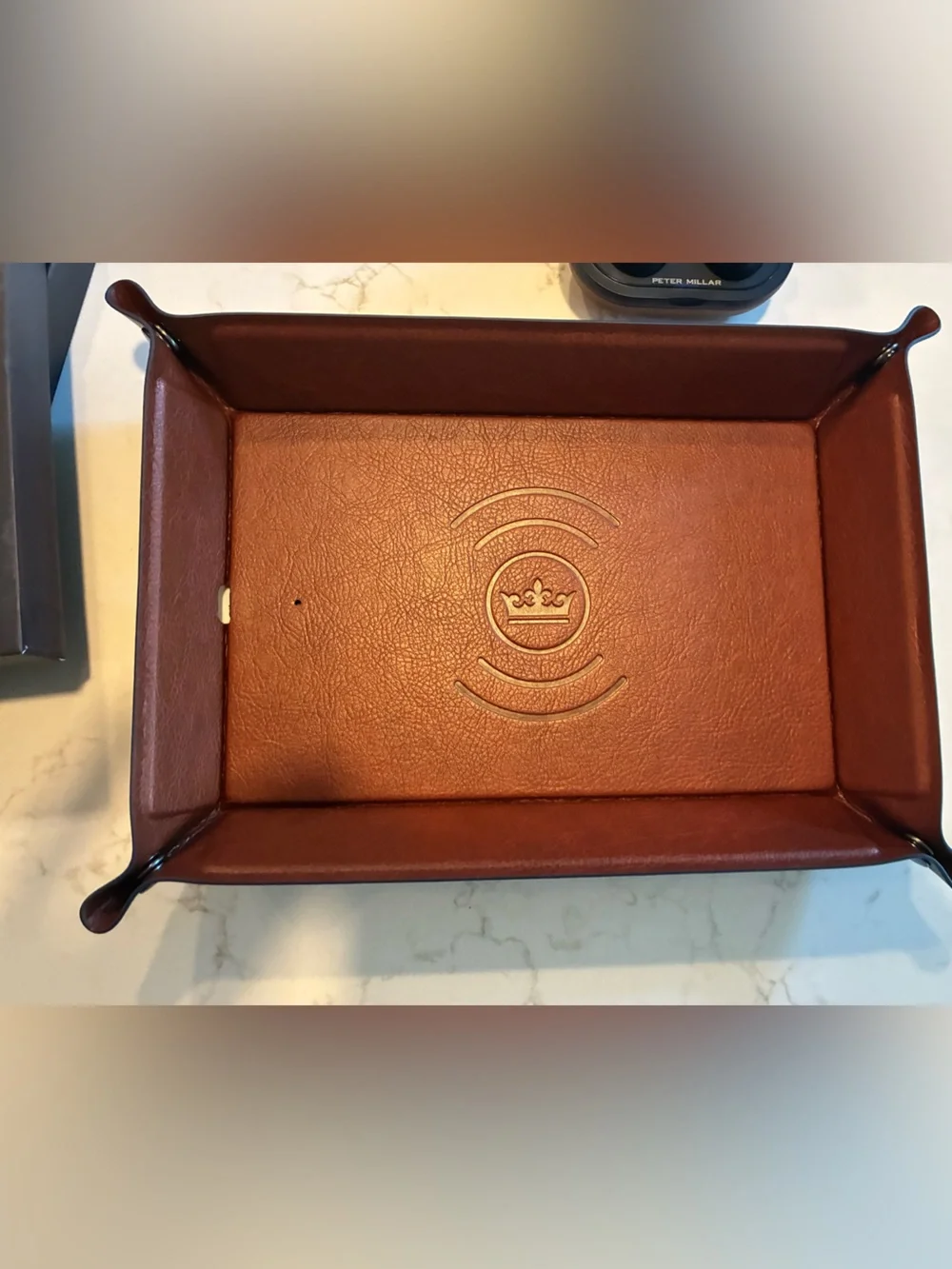 Peter Millar wireless charging catch and wireless headphones